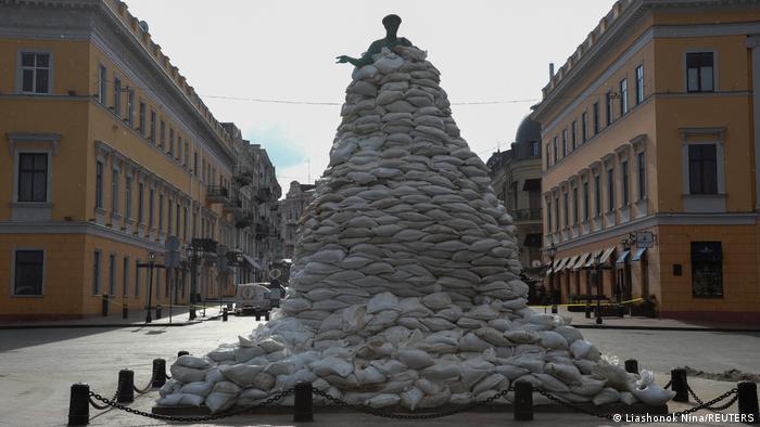 A monument is seen covered with sand bags for protection 