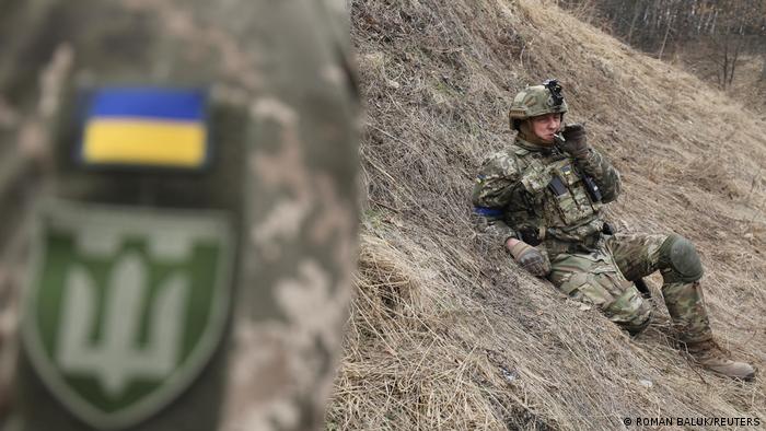  A member of the Ukrainian Territorial Defense Forces rests during tactical exercises