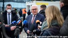 German President Frank-Walter Steinmeier (C) speaks with media representatives after he spoke with Ukrainian refugees and volunteers from the Berlin City Mission while visiting a tent to welcome refugees from Ukraine set up at the main train station in Berlin, Germany, on March 17, 2022. - Several thousand refugees from Ukraine have been arriving at the train station in the German capital recently every day, with the number of people arriving expected to rise. (Photo by Bernd von Jutrczenka / POOL / AFP) (Photo by BERND VON JUTRCZENKA/POOL/AFP via Getty Images)