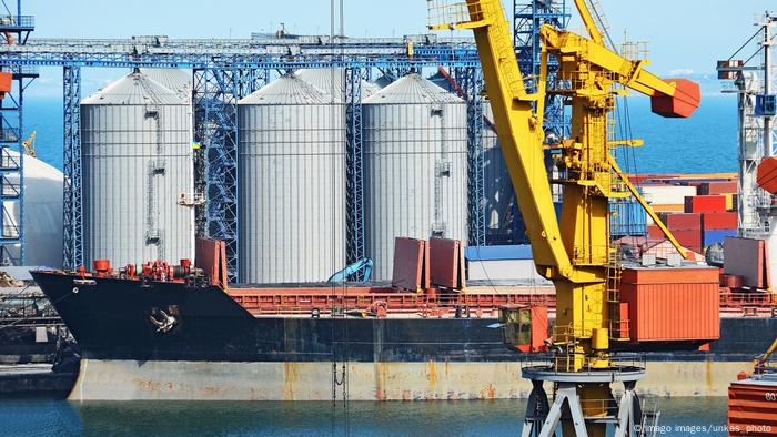 Odessa port, several tall silos, a ship and a crane