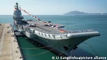 (191228) -- BEIJING, Dec. 28, 2019 (Xinhua) -- Photo taken on Dec. 17, 2019 shows the Shandong aircraft carrier at a naval port in Sanya, south China's Hainan Province. China's first domestically built aircraft carrier, the Shandong, was delivered to the People's Liberation Army (PLA) Navy and placed in active service on Dec. 17 at a naval port in Sanya. The new aircraft carrier, named after Shandong Province in east China, was given the hull number 17. (Xinhua/Li Gang)