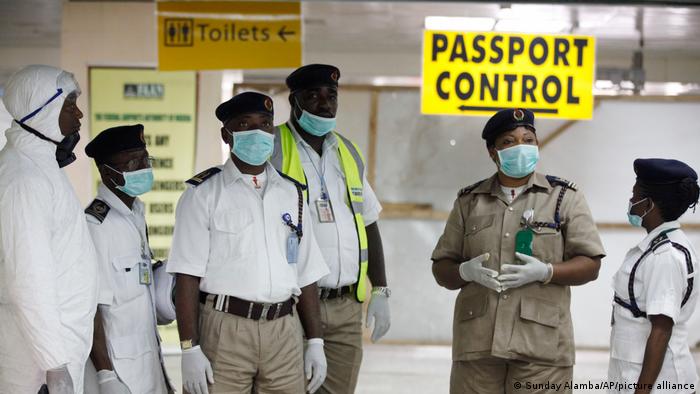 Nigerian port health officials wait to screen passengers at the arrivals hall of Murtala Muhammed International Airport in Lagos, Nigeria