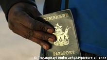 A man puts an expired passport in his pocket while waiting in a queue to submit an application for a new passport at the main office in Harare, Friday, June 14, 2019. With Zimbabwe’s economy in shambles and political tensions rising, leaving the country seems the best option for many who are desperate for jobs. But those dreams often end at the passport office, which doesn’t have enough foreign currency to import proper paper and ink. (AP Photo/Tsvangirayi Mukwazhi)