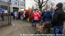 Refugees from Ukraine are standing in a line at the aid point which was opened at Henryk Reymanâs Municipal Stadium. Krakow, Poland on March 9th, 2022. Citizens of Krakow donated food, clothes and other supplies for Ukrainian refugees who fled to Poland after Russian military attack on Ukraine. (Photo by Beata Zawrzel/NurPhoto)