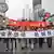 People hold banners while marching during an anti-Japan protest in Chengdu, in southwest China's Sichuan province, Saturday, Oct. 16, 2010. Chinese characters on the banners read, "All Chinese Unify To Boycott Japanese Products," and "Down With Japan, Return Us Diaoyu Island." Thousands of Chinese have protested against Japan and its claim to disputed islands at demonstrations that were far larger than past protests on the issue.(AP Photo) ** CHINA OUT **