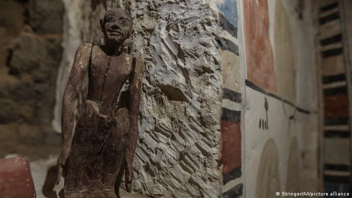 A small statuette is seen inside one of the five ancient Pharaonic tombs recently discovered at the Saqqara archaeological site