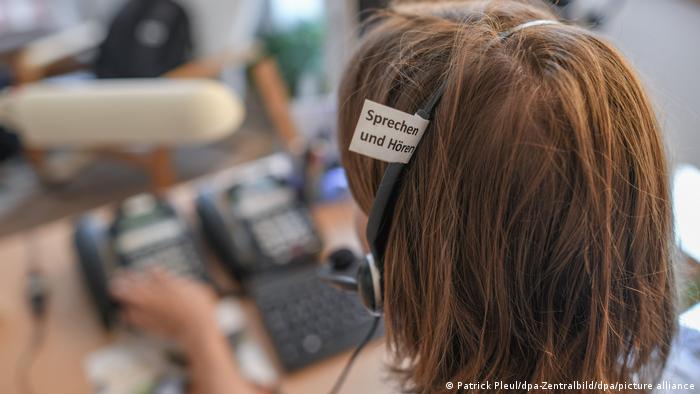 A worker at a phone service providing mental health counseling in Germany