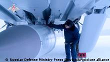 ******Achtung: In this photo taken from video provided by the Russian Defense Ministry Press Service on Saturday, Feb. 19, 2022, a Russian military technician checks a MiG-31K fighter of the Russian air force carrying a Kinzhal hypersonic cruise missile parked at an air field during a military drills. The Russian military on Friday announced massive drills of its strategic nuclear forces. Russian President Vladimir Putin will personally oversee Saturday's exercise, which will involve multiple practice launches of intercontinental ballistic missiles and cruise missiles, the Defense Ministry said. (Russian Defense Ministry Press Service via AP)