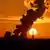 Plumes of smoke from Niederaussem coal power plant aginst sunset in Germany