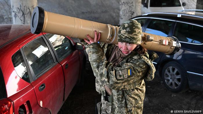 A Ukrainian soldier carries an anti-tank guided missile to the front line
