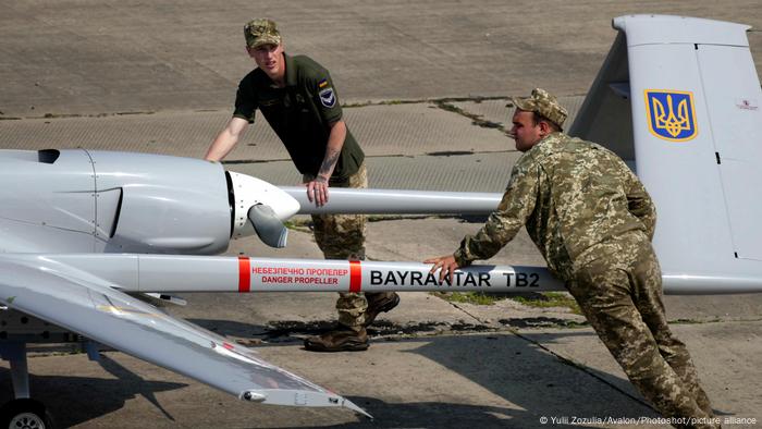 Ukrainian servicemen push a Bayraktar TB2 UCAV at the Kulbakyne aerodrome