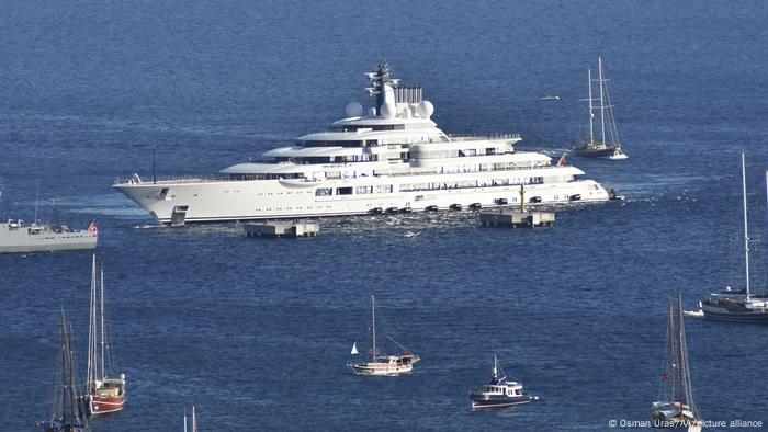 Mega yacht Scheherazade sails next to several smaller boats