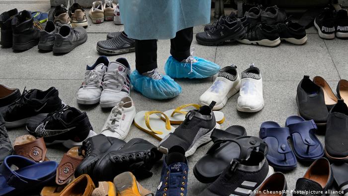 Die Schuhe der Impfwilligen sammeln sich vor den Türen der Kowloon-Moschee.