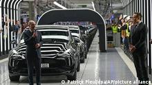 German Chancellor Olaf Scholz, left, talks to Elon Musk, Tesla CEO, at the opening of the Tesla factory Berlin Brandenburg in Gruenheide, Germany, Tuesday, March 22, 2022. The first European factory in Gruenheide, designed for 500,000 vehicles per year, is an important pillar of Tesla's future strategy. (Patrick Pleul/Pool via AP)