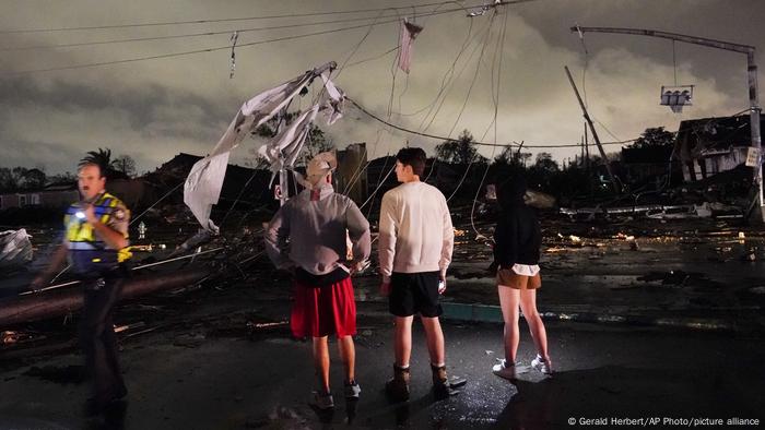 People assess damage at Lower Ninth Ward, a neighborhood in New Orleans