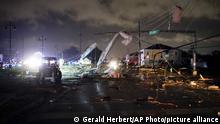 A debris lined street is seen in the Lower 9th Ward, Tuesday, March 22, 2022, in New Orleans, after strong storms moved through the area. (AP Photo/Gerald Herbert)
