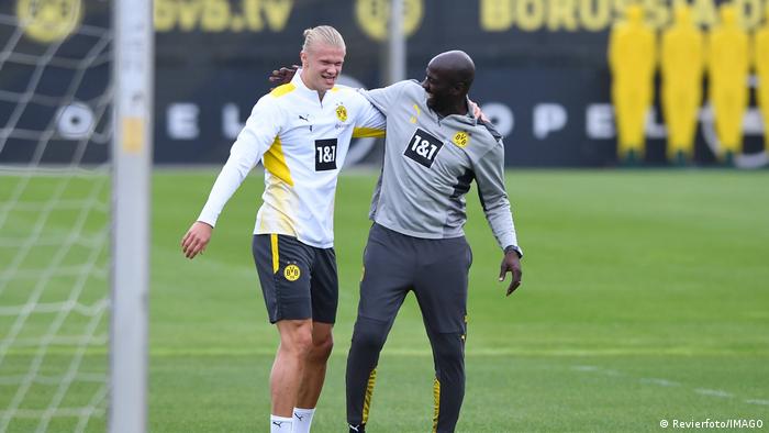 Otto Addo, right, shares a joke with Erling Haaland during a Borussia Dortmund training session