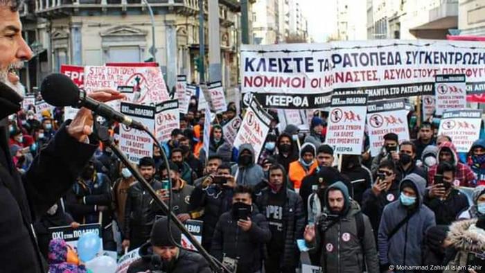 Bangladeshi migrants holding placards and banners stage a demonstration in Athens