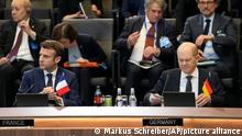 French President Emmanuel Macron, left, and German Chancellor Olaf Scholz, right, wait for the start of a round table meeting during an extraordinary NATO summit at NATO headquarters in Brussels, Thursday, March 24, 2022. As the war in Ukraine grinds into a second month, President Joe Biden and Western allies are gathering to chart a path to ramp up pressure on Russian President Vladimir Putin while tending to the economic and security fallout that's spreading across Europe and the world. (AP Photo/Markus Schreiber)
