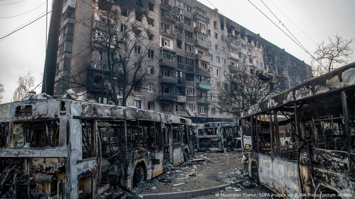 Burnt-out buses and apartments in Mariupol