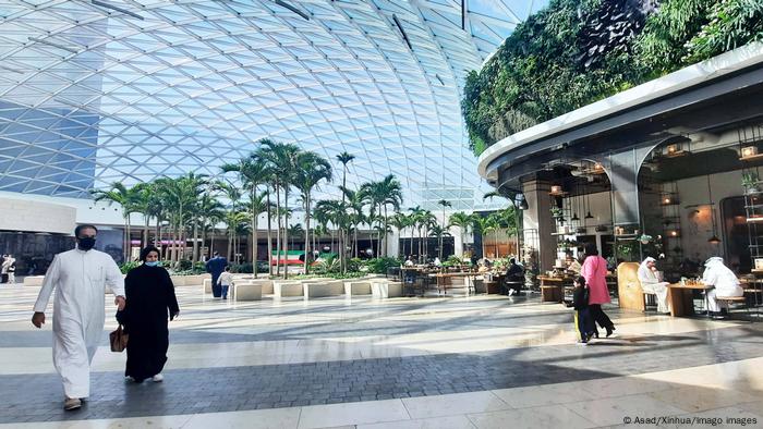 People walk inside a shopping mall in Farwaniya Governorate, Kuwait