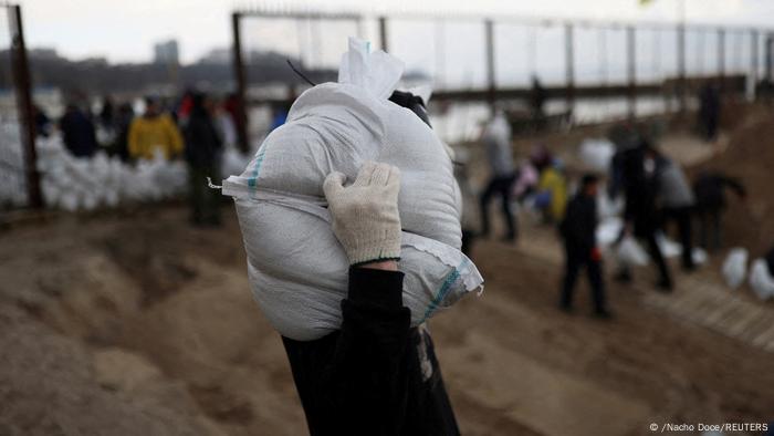 Viktor, 32, carries sandbags filled with sand from Sobachyy beach