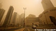 Cars drive along a highway during a heavy sand storm in Kuwait City on March 4, 2022. (Photo by YASSER AL-ZAYYAT / AFP)