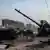 Destroços do que parece ser um tanque russo em meio a paisagem urbana