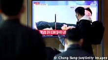 SEOUL, SOUTH KOREA - MARCH 24: People watch a TV at the Seoul Railway Station showing a file image of a North Korean missile launch on March 24, 2022 in Seoul, South Korea. North Korea fired an intercontinental ballistic missile (ICBM) toward the East Sea on Thursday, South Korea's military said, a move sharply escalating tensions in the region. (Photo by Chung Sung-Jun/Getty Images)