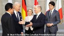 Prime Minister Justin Trudeau and U.S. President Joe Biden look on as German Chancellor Olaf Scholz gestures to Japan's Prime Minister Fumio Kishida as they arrive to take part in a G7 family photo at NATO headquarters in Brussels, Belgium on Thursday, March 24, 2022. (Sean Kilpatrick/The Canadian Press via AP)
