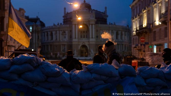 Soldiers standing behind sandbags in front of the National Academic Theater of Opera and Ballet in Odesa