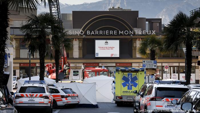 Police and rescue personnel stand in front of the cordoned off area near the Montreux Casino.
