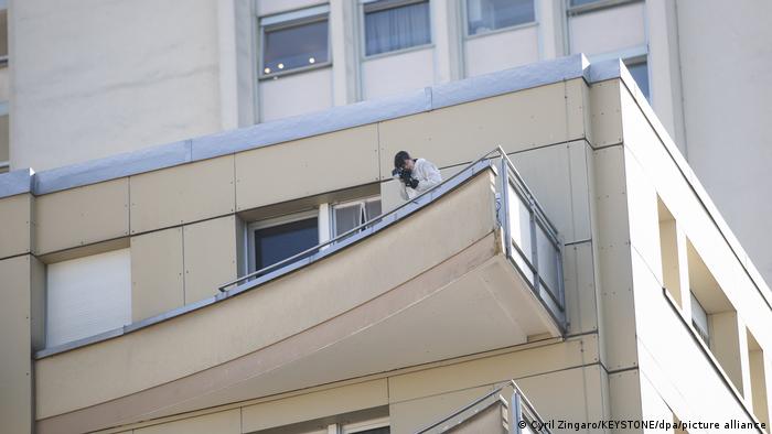 A detective on the balcony of the residential building.
