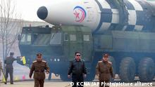 In this photo distributed by the North Korean government, North Korean leader Kim Jong Un, center, walks around what it says a Hwasong-17 intercontinental ballistic missile (ICBM) on the launcher, at an undisclosed location in North Korea on March 24, 2022. Independent journalists were not given access to cover the event depicted in this image distributed by the North Korean government. The content of this image is as provided and cannot be independently verified. Korean language watermark on image as provided by source reads: KCNA which is the abbreviation for Korean Central News Agency. (Korean Central News Agency/Korea News Service via AP)