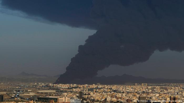 A massive column of black smoke billows over the Saudi Arabian city of Jiddah