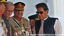 Pakistan's Prime Minister Imran Khan, right, Army Chief General Qamar Javed Bajwa, center, and Defense Minister Pervez Khattaq attend a military parade to mark Pakistan National Day in Islamabad, Pakistan, Wednesday, March 23, 2022. Pakistanis celebrated their National Day on Wednesday with a military parade in the capital, Islamabad, showcasing this Islamic nation's elite army units and high-tech weaponry, including short, medium, and long-range missiles, tanks, fighter jets and other hardware. (Anjum Naveed)