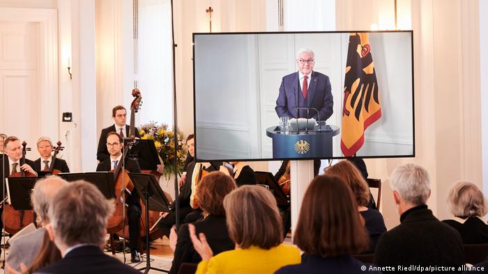 Frank-Walter Steinmeier appears via videolink as an audience watches musicians play