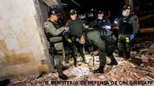 Handout picture released on March 27, 2022 by Colombia's Ministry of Defense showing Colombian Army bomb squad members checking damages at a police station in Simon Bolivar neighborhood in Bogota, following an attack with explosives on the eve. - A 12-year-old boy died and 18 other people - including several minors - were injured in an attack with explosives against a police station in a popular neighborhood of Bogotá, authorities reported. (Photo by Handout / MINISTERIO DE DEFENSA DE COLOMBIA / AFP) / RESTRICTED TO EDITORIAL USE - MANDATORY CREDIT 'AFP PHOTO / MINISTERIO DE DEFENSA DE COLOMBIA' - NO MARKETING - NO ADVERTISING CAMPAIGNS - DISTRIBUTED AS A SERVICE TO CLIENTS