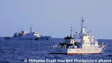 In this photo provided by the Philippine Coast Guard, a Chinese Coast Guard ship sails near a Philippine Coast Guard vessel during its patrol at Bajo de Masinloc, 124 nautical miles west of Zambales province northwestern Philippines on March 2, 2022. Chinese coast guard ships have maneuvered dangerously close to Philippine coast guard ships at least four times since last year near a disputed shoal that increased the risks of collision and violated international safety regulations, the Philippine coast guard said Sunday. (Philippine Coast Guard via AP)