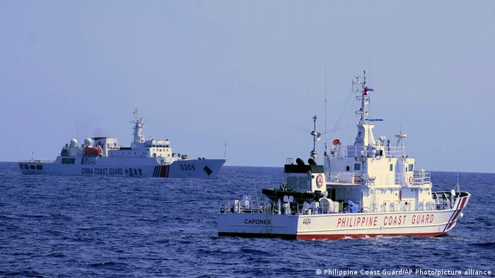 In this photo provided by the Philippine Coast Guard, a Chinese Coast Guard ship sails near a Philippine Coast Guard vessel during its patrol at Bajo de Masinloc