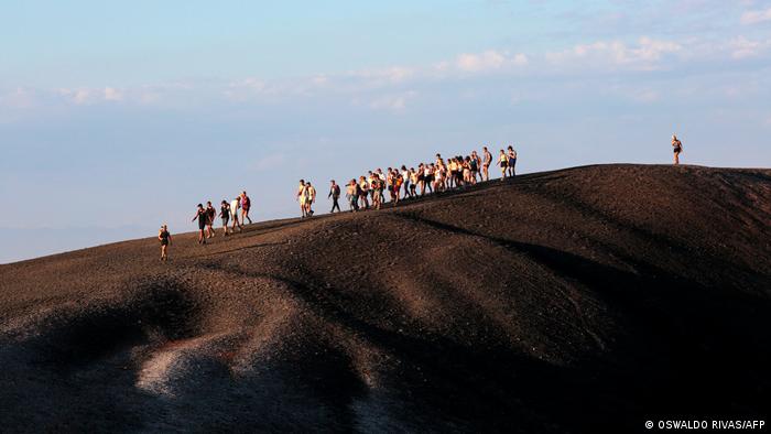 A group of tourists are seen from afar on Cerro Negro 