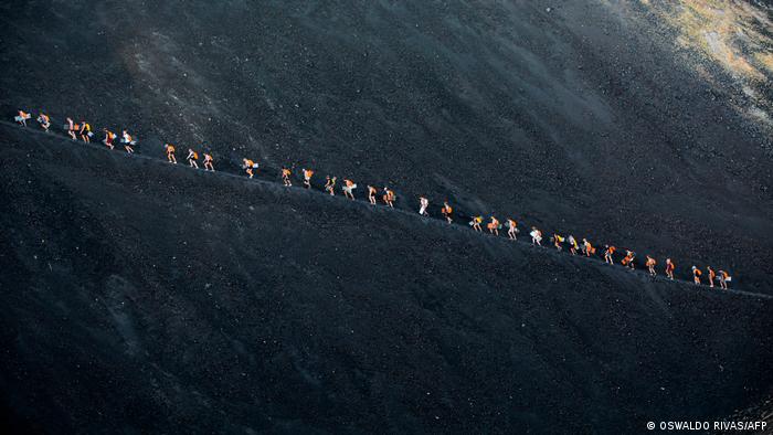 A group of tourists ascend 728-meter tall Cerro Negro