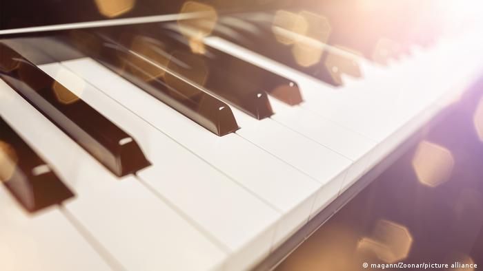 Piano keys shine in the sunlight 