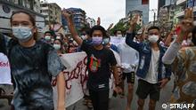 Protesters hold up the three-finger salute during a demonstration against the military coup in Yangon
