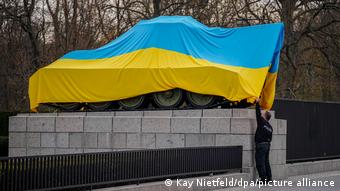 Сотрудники полиции снимают флаг Украины с советского танка в мемориальном комплексе Берлин-Тиргартен