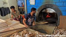 Workers prepare bread at a bakery in the war-torn Yemeni capital Sanaa, on February 28, 2022. - Russia's invasion of Ukraine could mean less bread on the table in Egypt, Lebanon, Yemen and elsewhere in the Arab world where millions already struggle to survive. The region is heavily dependent on wheat supplies from the two countries which are now at war, and any shortages of the staple food have potential to bring unrest. (Photo by MOHAMMED HUWAIS / AFP)