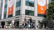 (210730) -- BERLIN, July 30, 2021 (Xinhua) -- Pedestrians walk past a shopping center in Berlin, capital of Germany, on July 30, 2021. Germany's gross domestic product (GDP) rose by 1.5 percent in the second quarter (Q2) this year compared with the previous quarter, the Federal Statistical Office (Destatis) said on Friday. (Photo by Stefan Zeitz/Xinhua)