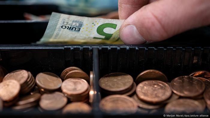 A 5 euro note and pennies in a till 