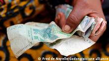 Woman using CFA Francs. Banknotes. Close-up. Lome. Togo.
