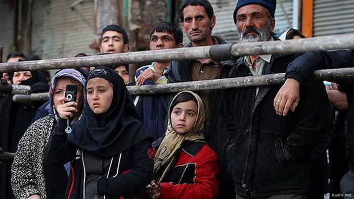 Spectators watch a public execution in Iran